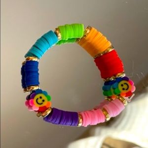 crafted toddler clay bead bracelet  rainbow smiley accents and gold accent beads